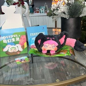 Duidui fantastic creatures this one is a coin purse or pouch she has a long tail